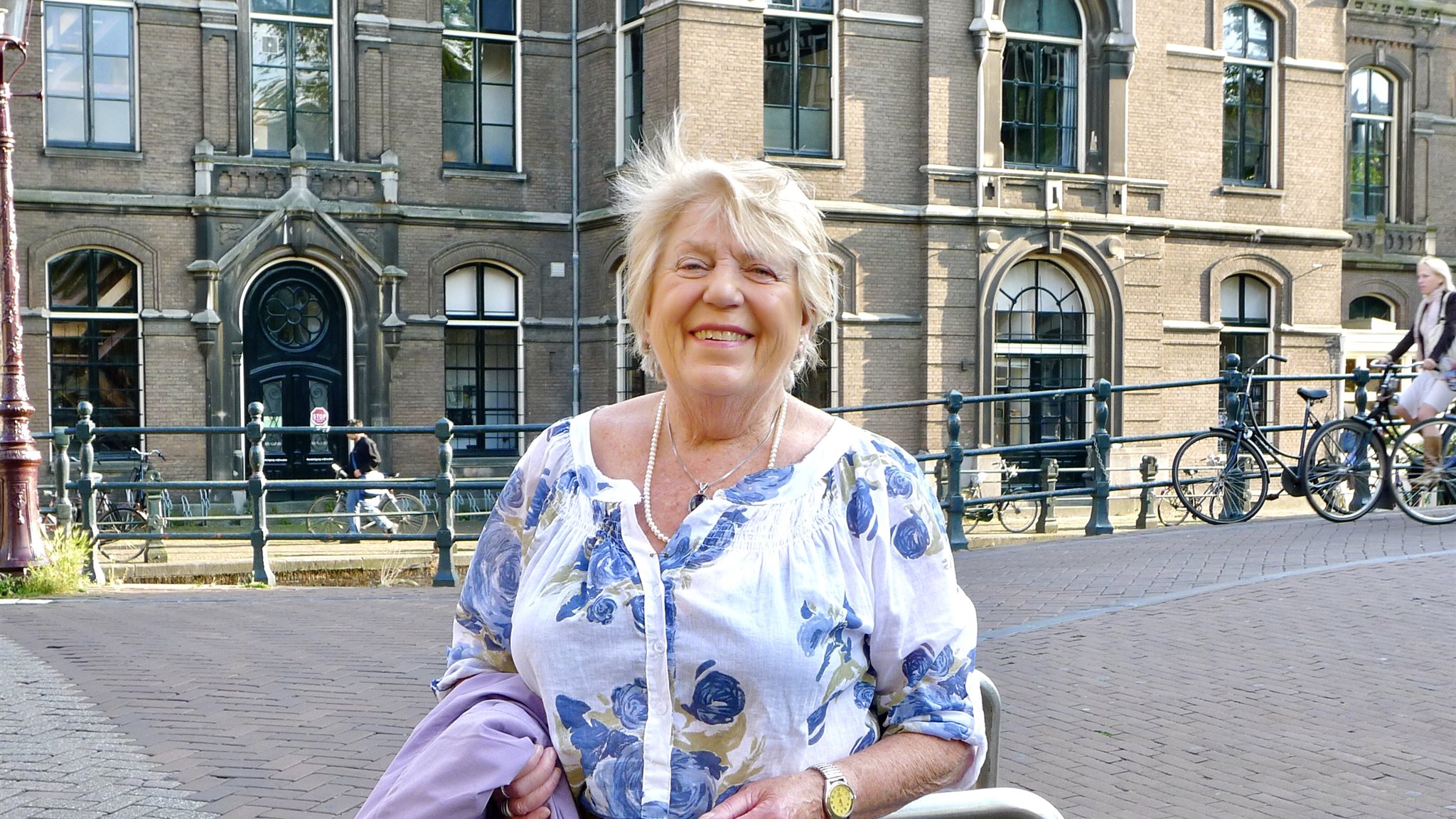 Netty Veldkamp-Wieringa, lachend op een brug in Amsterdam